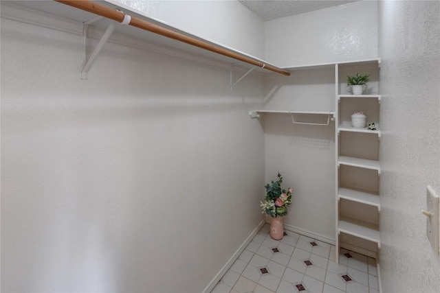 walk in closet featuring light tile patterned floors