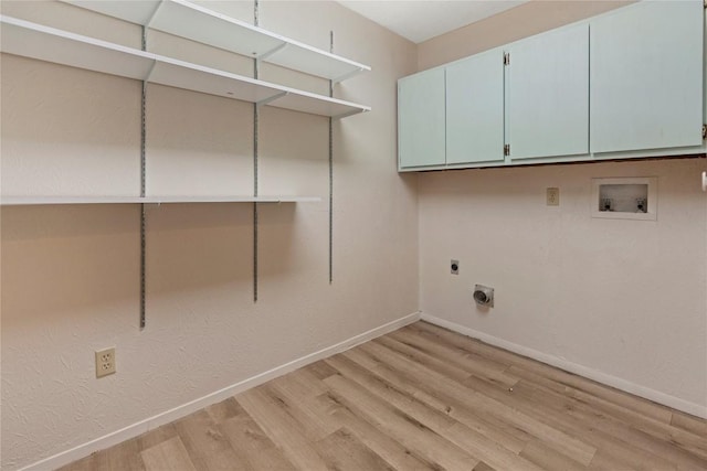 laundry room with baseboards, hookup for a washing machine, light wood-style floors, cabinet space, and electric dryer hookup
