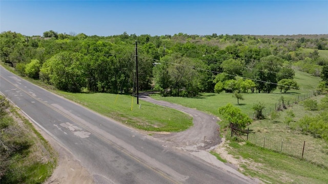 view of road with a forest view