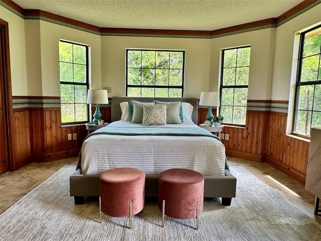 10400 Bitting School Rd, Manor, TX 78653 - bedroom with wainscoting, a textured ceiling, and wooden walls
