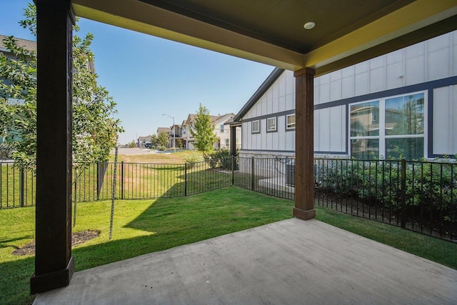 view of yard with a fenced backyard, a patio, and a residential view