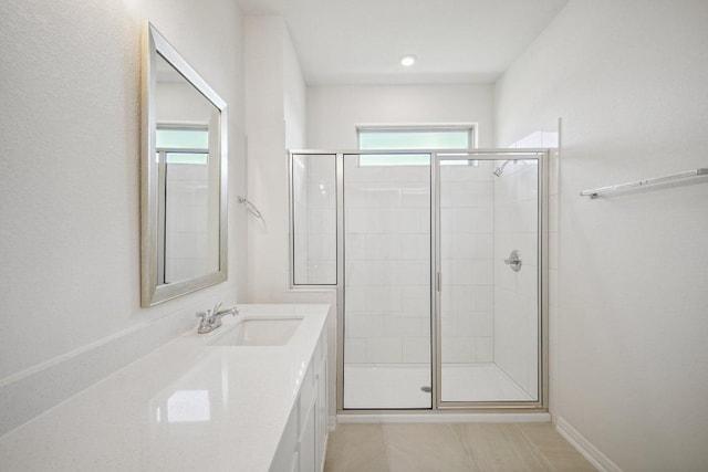bathroom featuring vanity, a shower stall, and plenty of natural light