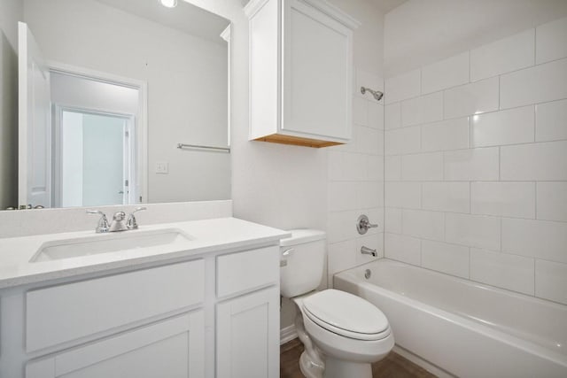 bathroom featuring shower / bathing tub combination, vanity, and toilet