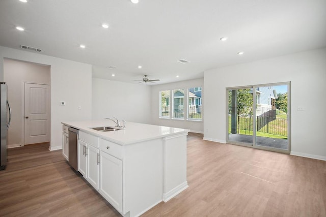 kitchen featuring a sink, appliances with stainless steel finishes, visible vents, baseboards, and light wood-style floors