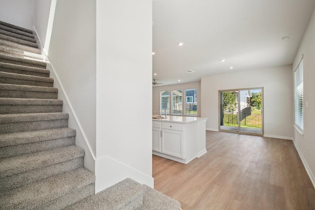 stairs with recessed lighting, baseboards, a ceiling fan, and wood finished floors