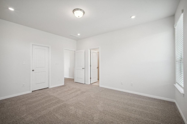 unfurnished bedroom with carpet, baseboards, and recessed lighting