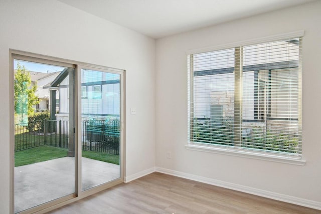 entryway featuring baseboards and wood finished floors