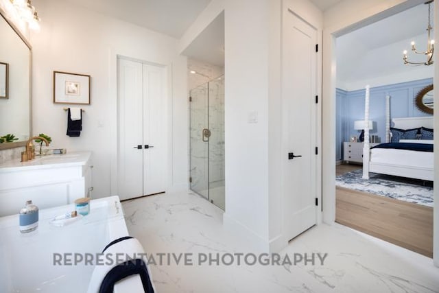 bathroom featuring ensuite bathroom, marble finish floor, vanity, a marble finish shower, and an inviting chandelier