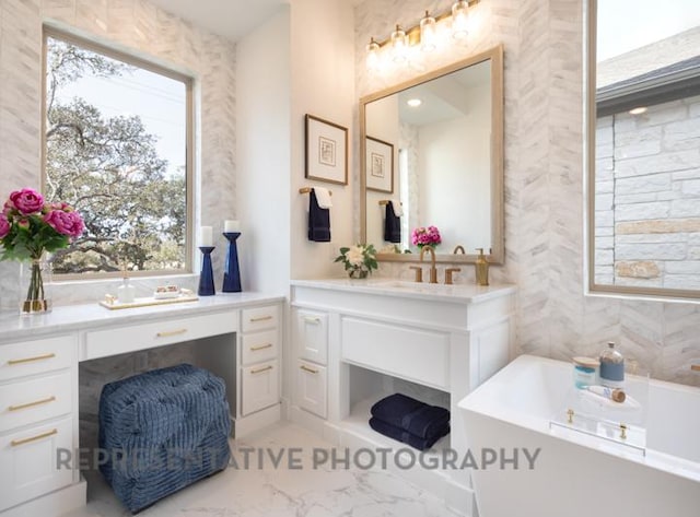 full bathroom featuring a bath, marble finish floor, and vanity