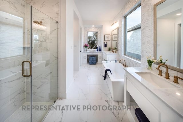 bathroom featuring vanity, a marble finish shower, marble finish floor, and a freestanding tub