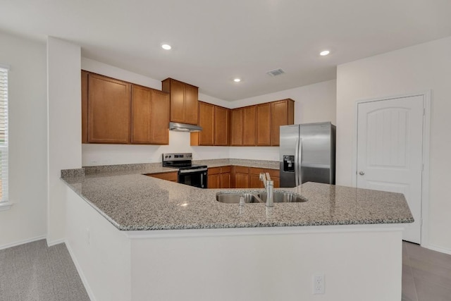 kitchen with brown cabinets, a sink, range with electric cooktop, stainless steel fridge with ice dispenser, and visible vents