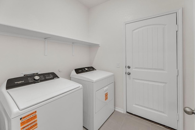 washroom with laundry area, washer and clothes dryer, and light tile patterned floors
