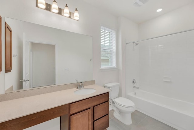 bathroom with tile patterned floors, toilet, vanity, and shower / bathtub combination