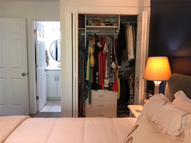 6409 Burns St Unit 306, Austin, TX 78752 - bedroom featuring a closet, ensuite bath, tile patterned flooring, and a sink