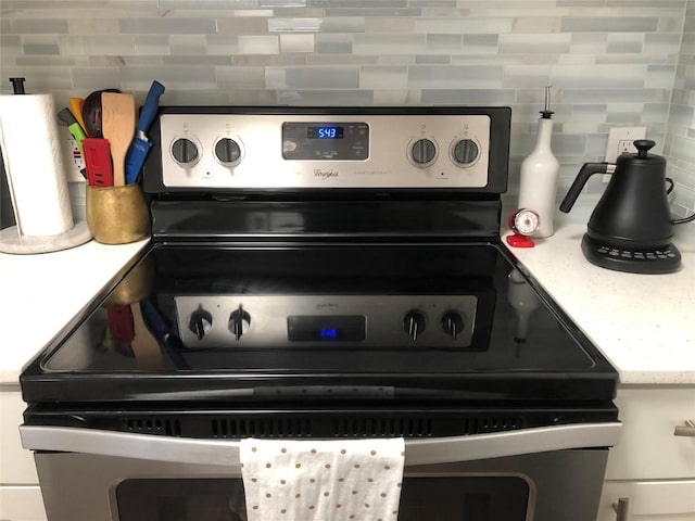 6409 Burns St Unit 306, Austin, TX 78752 - interior details with decorative backsplash, light countertops, and electric stove