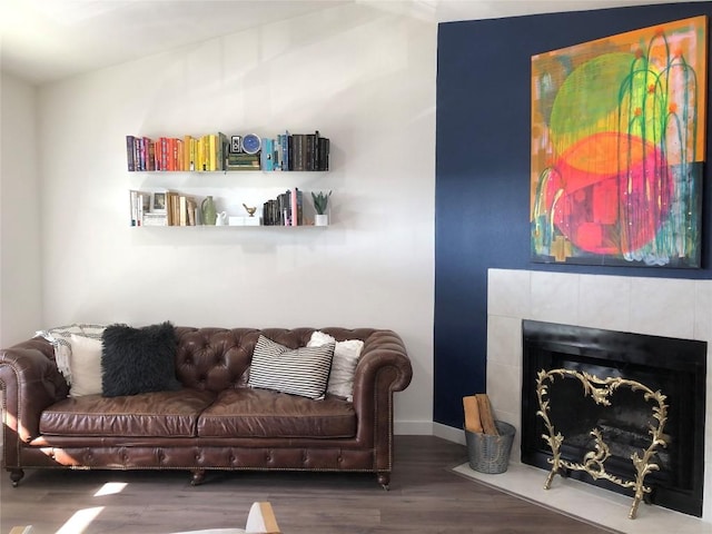 6409 Burns St Unit 306, Austin, TX 78752 - living area with baseboards, a tiled fireplace, and wood finished floors