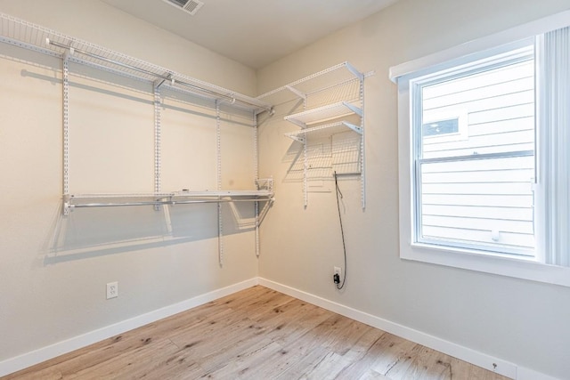 walk in closet featuring wood finished floors