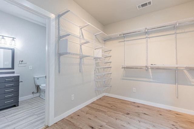 spacious closet featuring light wood-style floors and visible vents