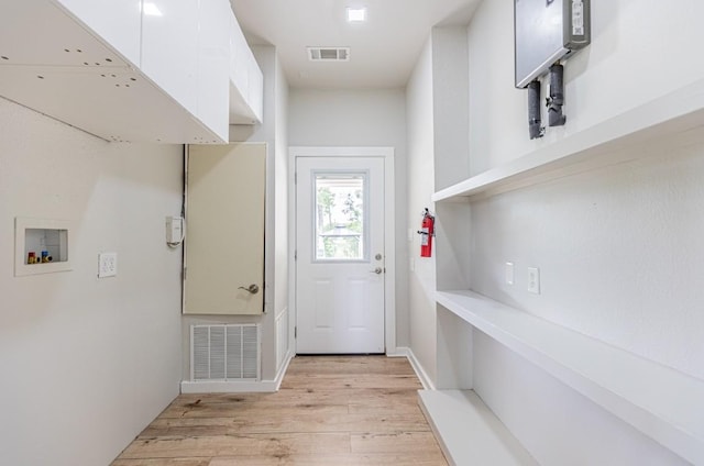 entryway with light wood finished floors and visible vents