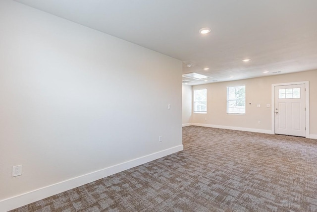 carpeted empty room with baseboards, a healthy amount of sunlight, and recessed lighting