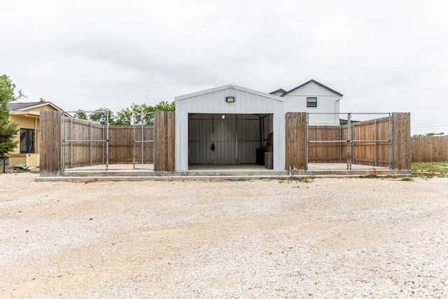 view of outbuilding featuring fence and an outbuilding