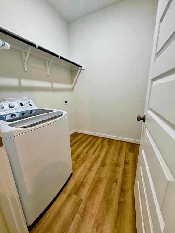 4319 Port Hope St, Round Rock, TX 78665 - washroom featuring washer / dryer, light wood-type flooring, and baseboards
