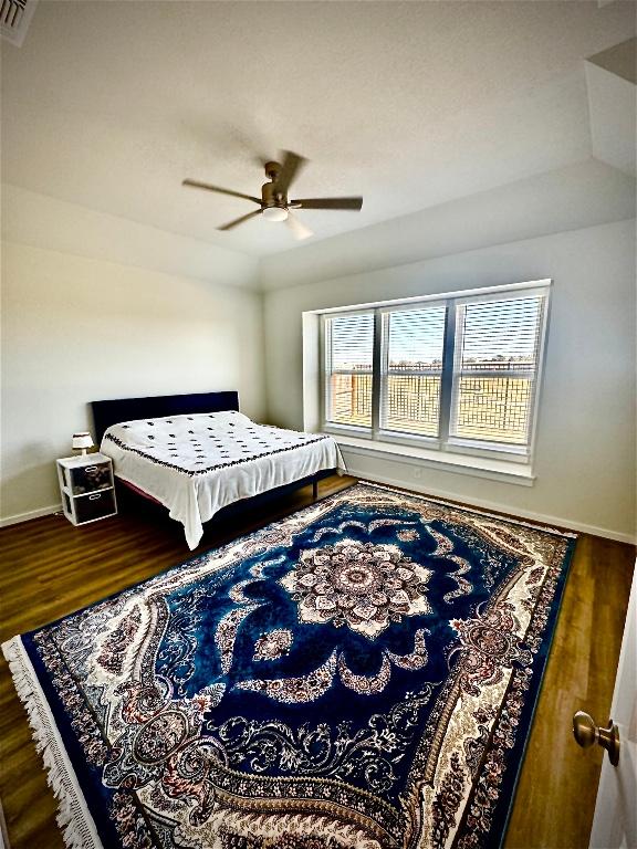 4319 Port Hope St, Round Rock, TX 78665 - bedroom with wood finished floors, baseboards, and a ceiling fan