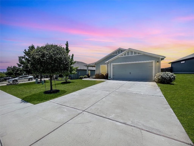 127 Navidad River Dr, Hutto, TX 78634 - ranch-style house with a lawn, concrete driveway, and a garage