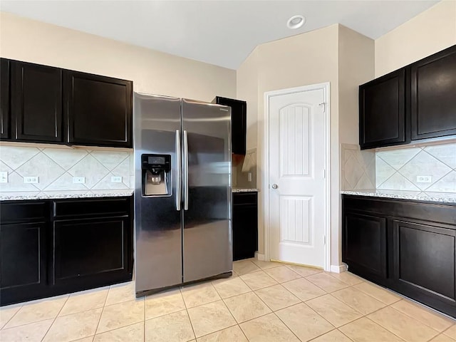 127 Navidad River Dr, Hutto, TX 78634 - kitchen featuring stainless steel refrigerator with ice dispenser, dark cabinetry, and tasteful backsplash