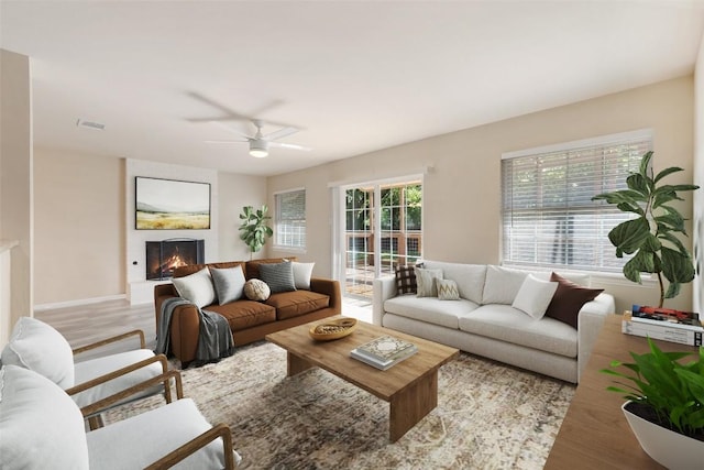 216 Lizzie St, Taylor, TX 76574 - living area with a fireplace, a ceiling fan, and wood finished floors