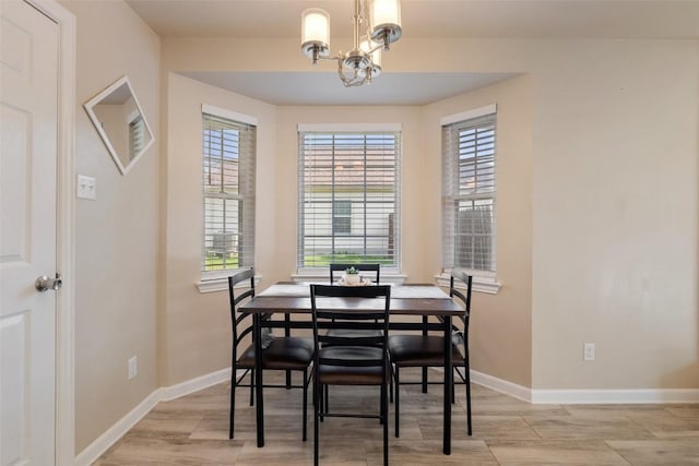 216 Lizzie St, Taylor, TX 76574 - dining room featuring a chandelier and light wood-type flooring