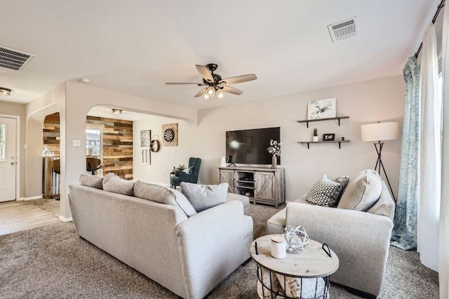 338 Liberty St, Hutto, TX 78634 - living room featuring arched walkways, ceiling fan, baseboards, and visible vents