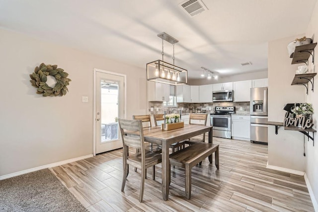 338 Liberty St, Hutto, TX 78634 - dining area featuring baseboards, light wood-style floors, and visible vents