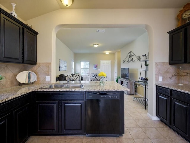 1401 Blake St, Leander, TX 78641 - kitchen with dishwasher, arched walkways, a peninsula, backsplash, and light tile patterned floors