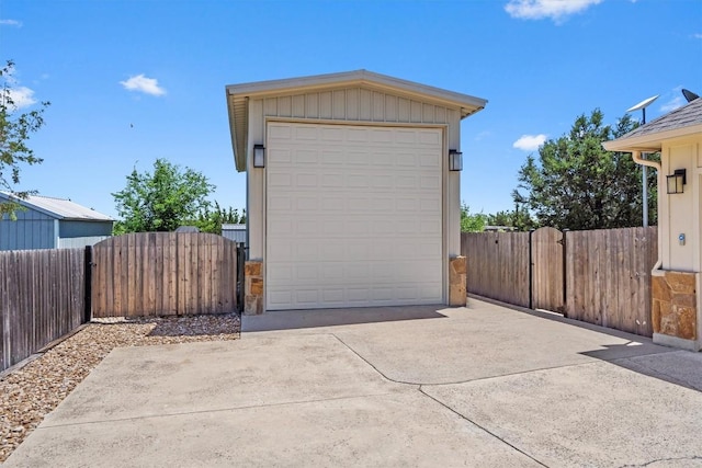 detached garage featuring a gate and fence