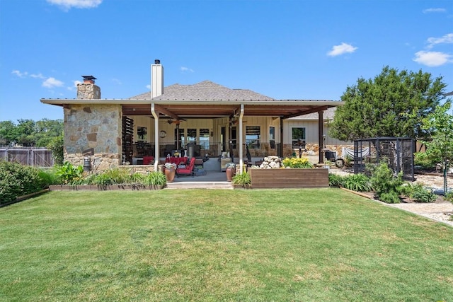 back of house with a patio, a chimney, a lawn, and an outdoor living space