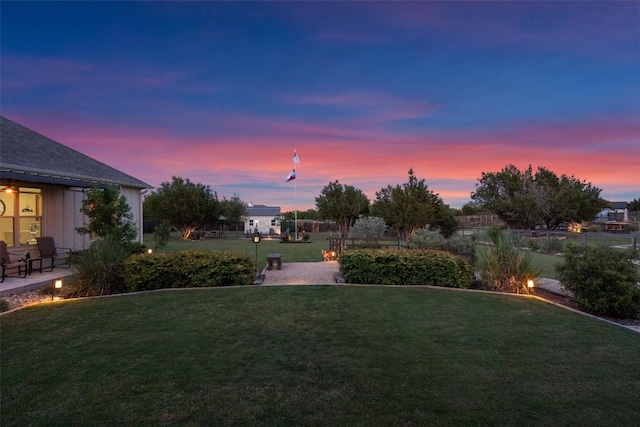 yard at dusk featuring a patio area