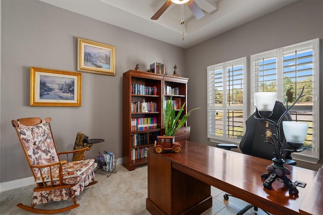 office with ceiling fan and baseboards