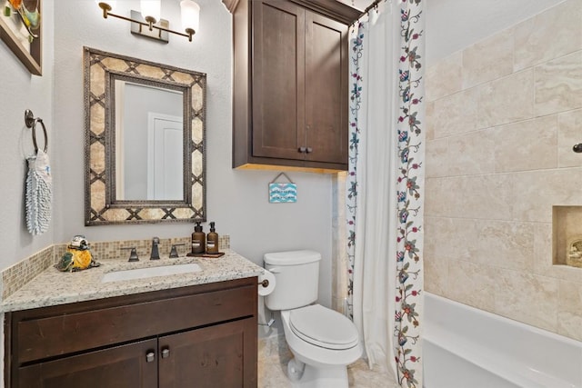 bathroom featuring toilet, vanity, and shower / tub combo
