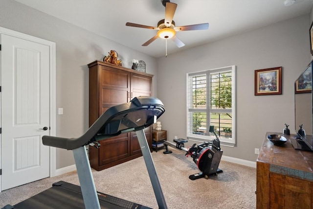 exercise area with ceiling fan, carpet, and baseboards