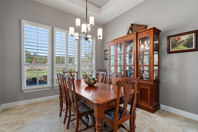 dining room featuring baseboards, a notable chandelier, and plenty of natural light
