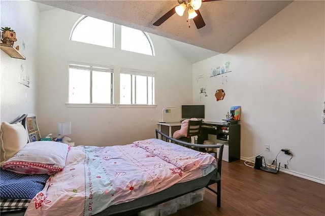 bedroom with vaulted ceiling, a ceiling fan, and wood finished floors