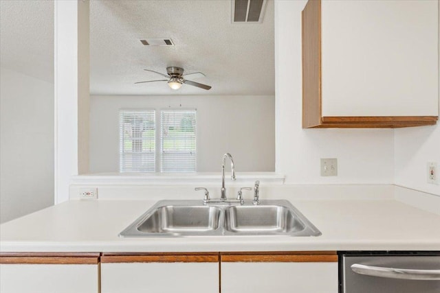 1015 E Yager Ln Unit 157, Austin, TX 78753 - kitchen with a sink, dishwasher, light countertops, ceiling fan, and a textured ceiling