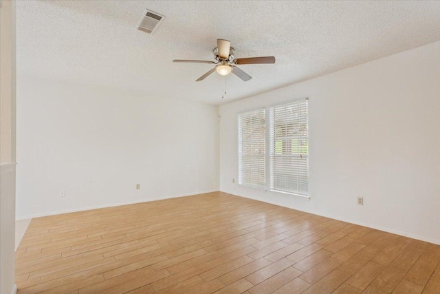 1015 E Yager Ln Unit 157, Austin, TX 78753 - unfurnished room featuring ceiling fan, light wood-style floors, and a textured ceiling