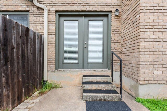 1015 E Yager Ln Unit 157, Austin, TX 78753 - doorway to property with french doors and brick siding