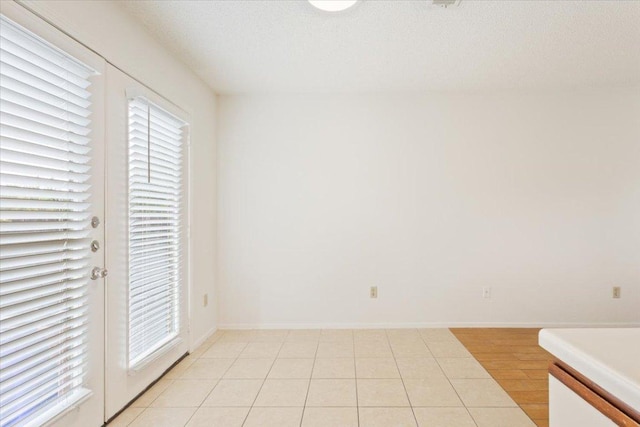 1015 E Yager Ln Unit 157, Austin, TX 78753 - unfurnished bedroom featuring light tile patterned floors and a textured ceiling