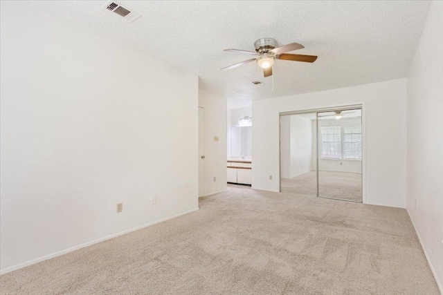 1015 E Yager Ln Unit 157, Austin, TX 78753 - carpeted empty room with ceiling fan, a textured ceiling, and baseboards