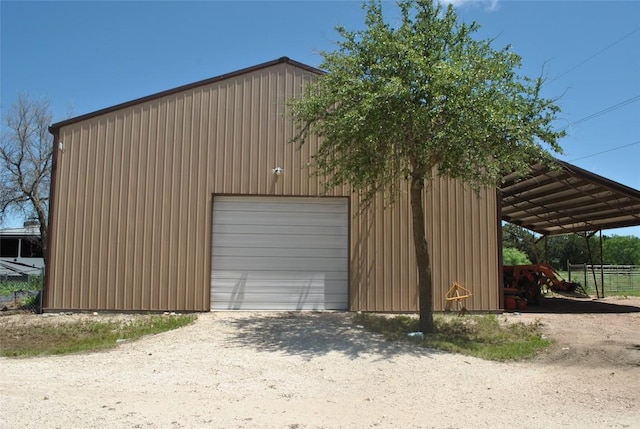 exterior space with a detached garage and driveway