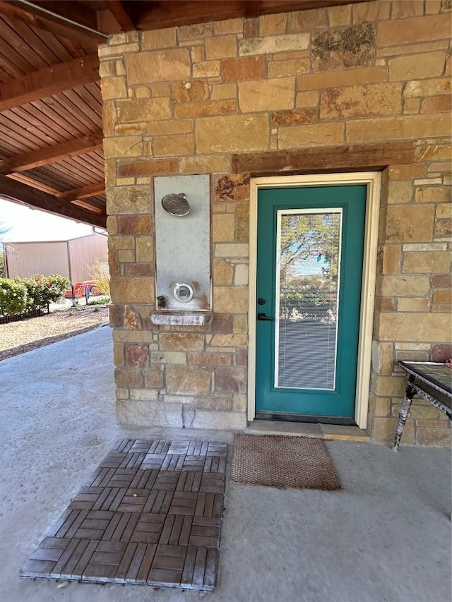 entrance to property featuring stone siding