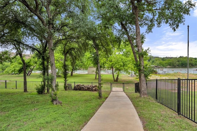 view of community with a yard and fence